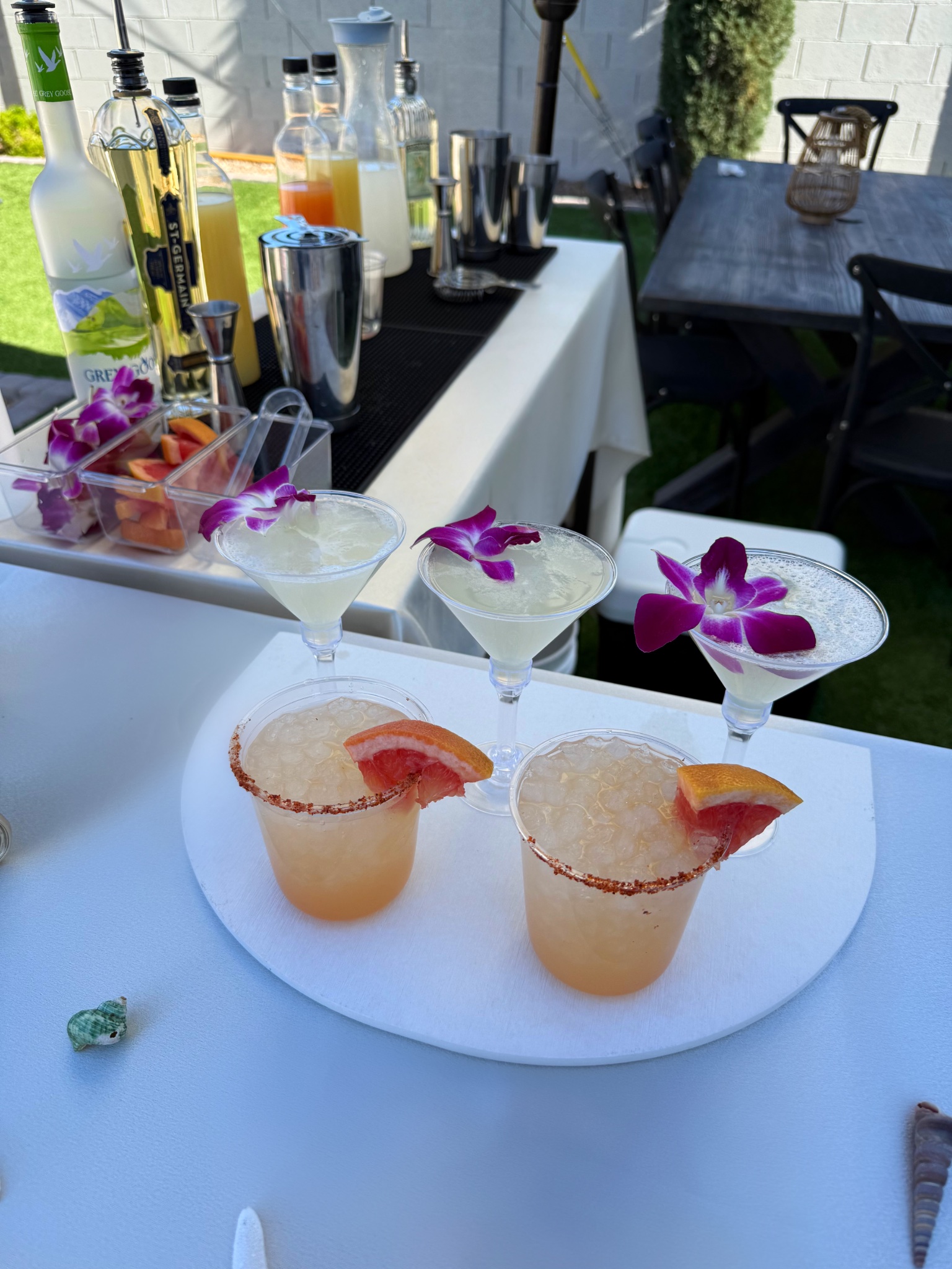 Outdoor beach-themed bar setup with cocktails
